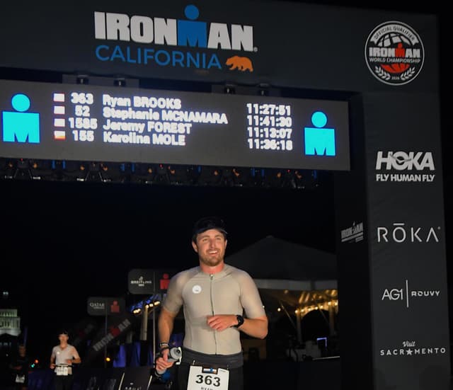 Ryan crossing the Ironman finish line